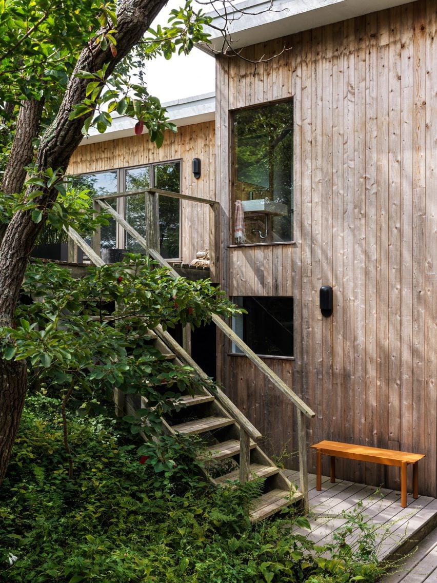 Exterior staircase next to house with vertical timber cladding