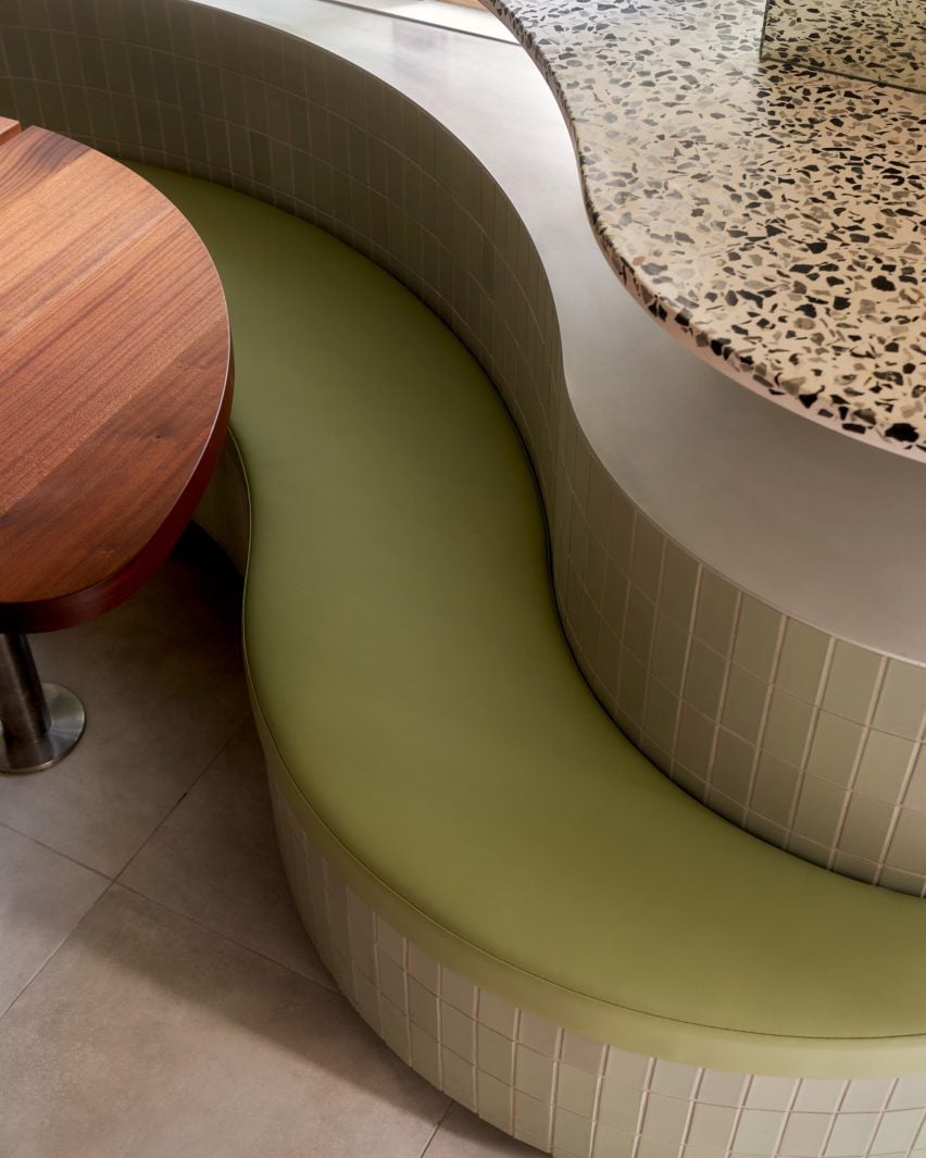Pistachio-coloured leather seat cushion against a tiled back and base