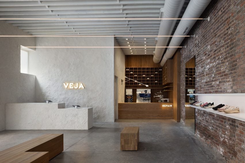 View of a lime plaster sales counter and a white oak-clad repair shop