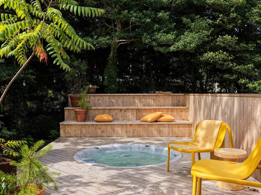 Circular hot tub recessed into a raised timber deck