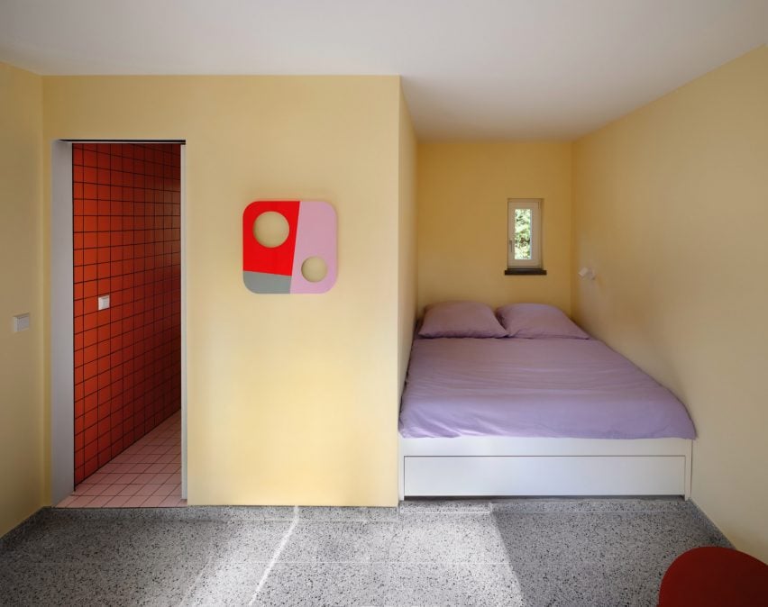 Pastel yellow bedroom with purple bed