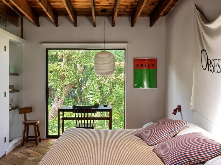 Bedroom with large picture window overlooking trees